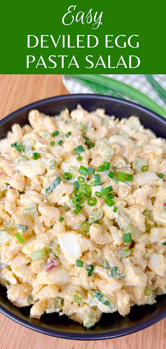 a black bowl is filled with deviled egg pasta salad and garnished with green onions. text overlay reads easy deviled egg pasta salad.