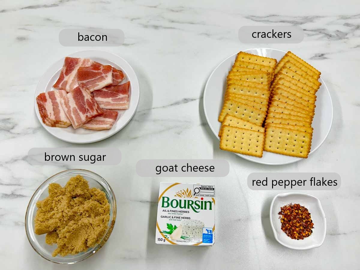 a counter top with the ingredients to make candied bacon boursin crackers with text overlay reading bacon, crackers, brown sugar, boursin, red pepper flakes