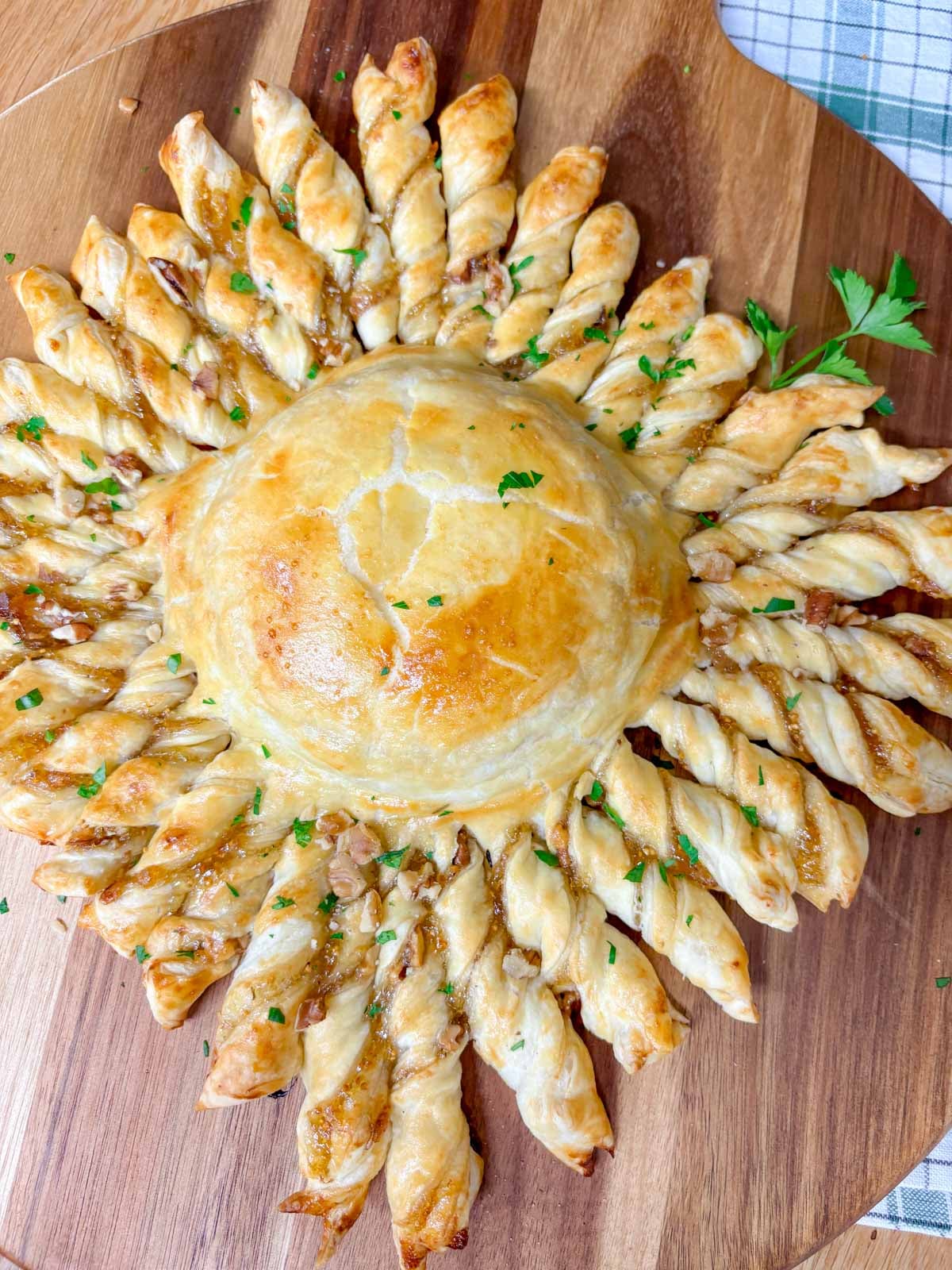 a wood serving board has a twisted pastry ring 