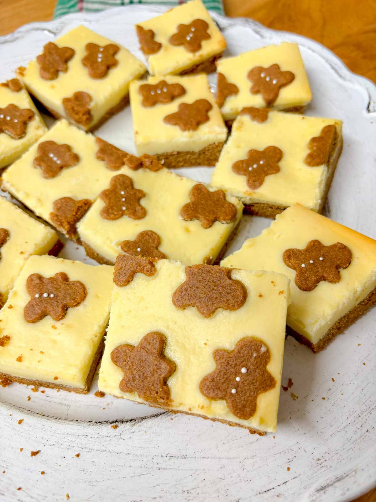a white plate is filled with gingerbread cookie bars.