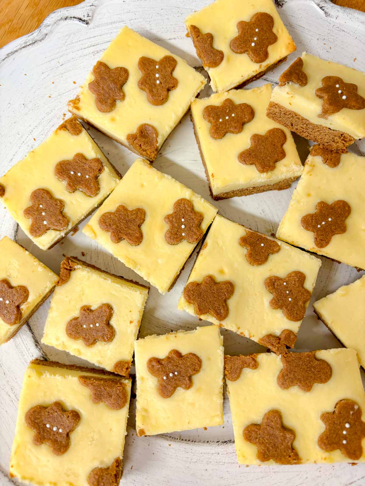 a white plate is filled with gingerbread cookie bars.