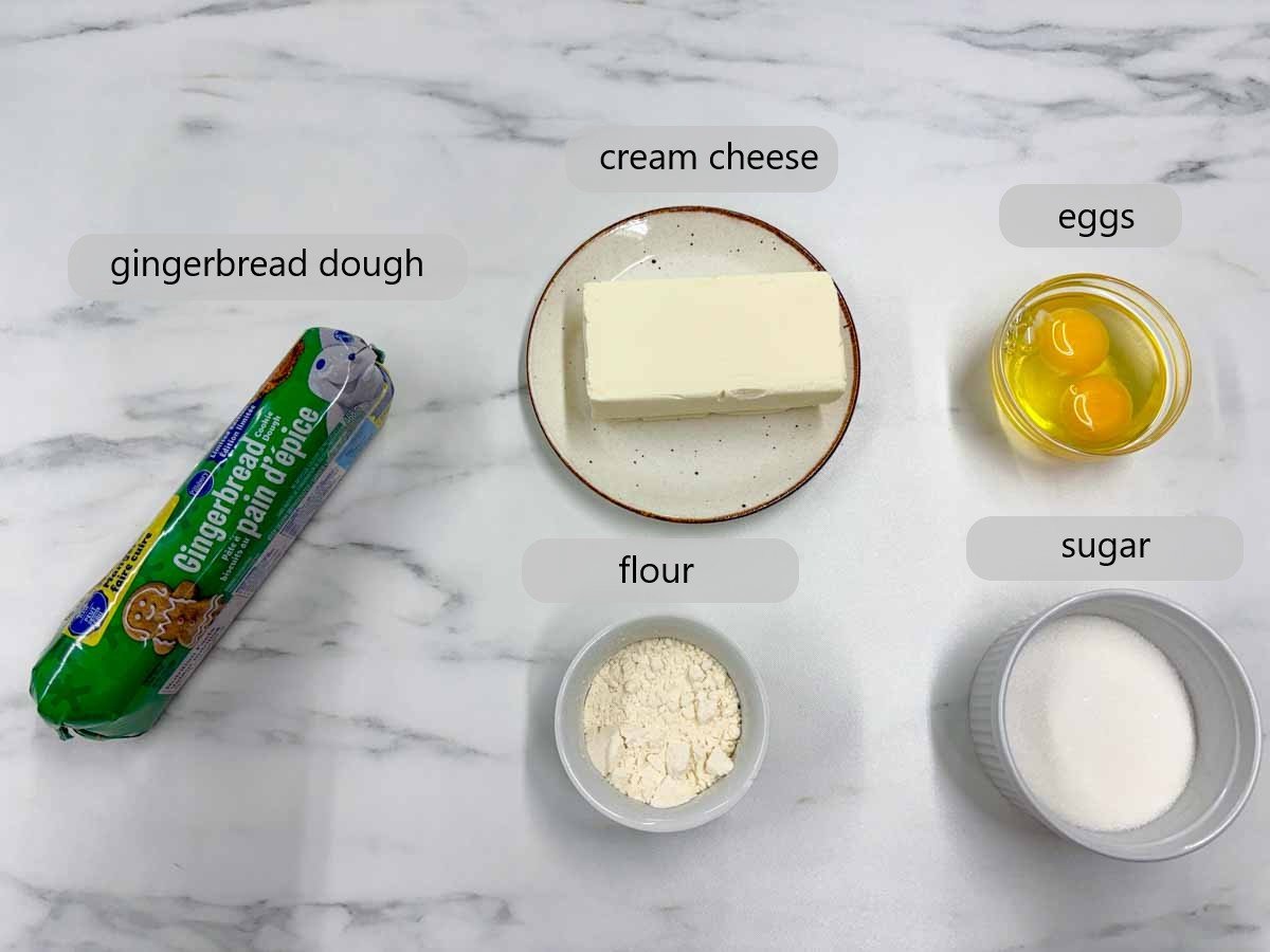 kitchen counter with bowls of ingredients and text overlays reading gingerbread cookie dough, cream cheese, eggs, flour, sugar.