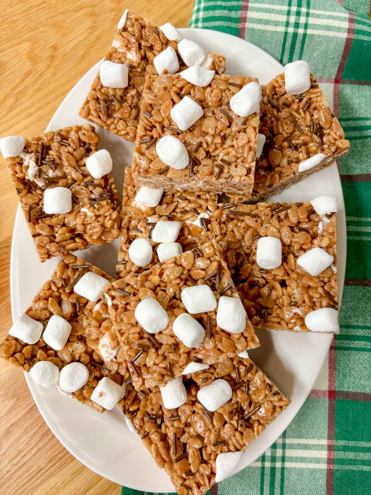 a white platter is filled with hot chocolate rice krispie treats.