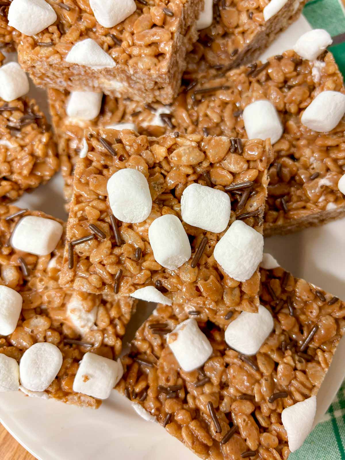 a white platter is filled with hot chocolate rice krispie treats.