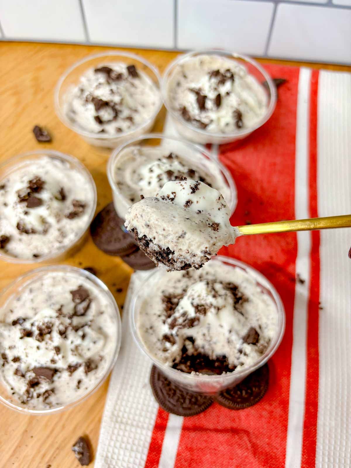 a spoon picks up some of the oreo cheesecake