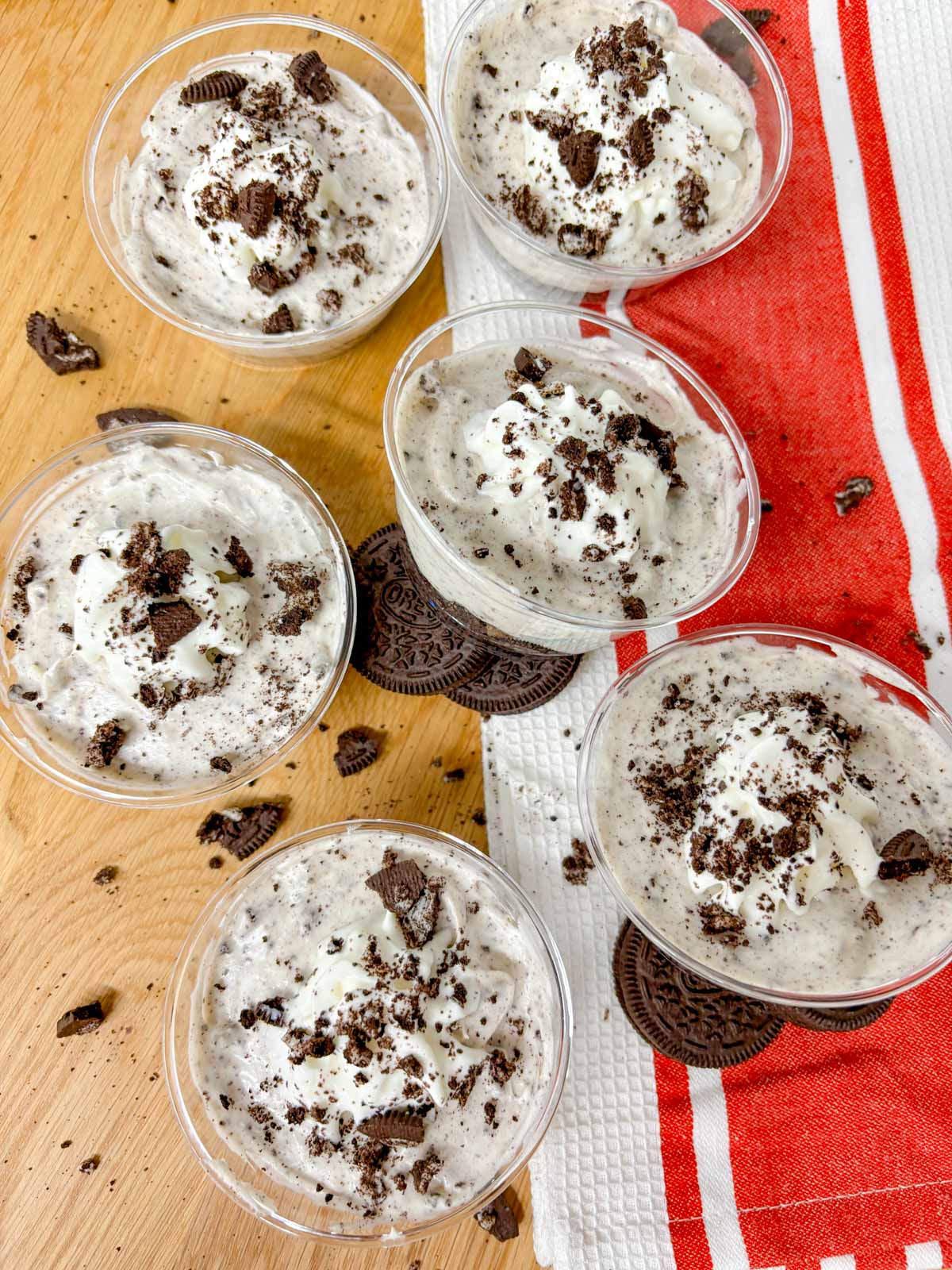 oreo cheesecake cups are arranged on a kitchen counter