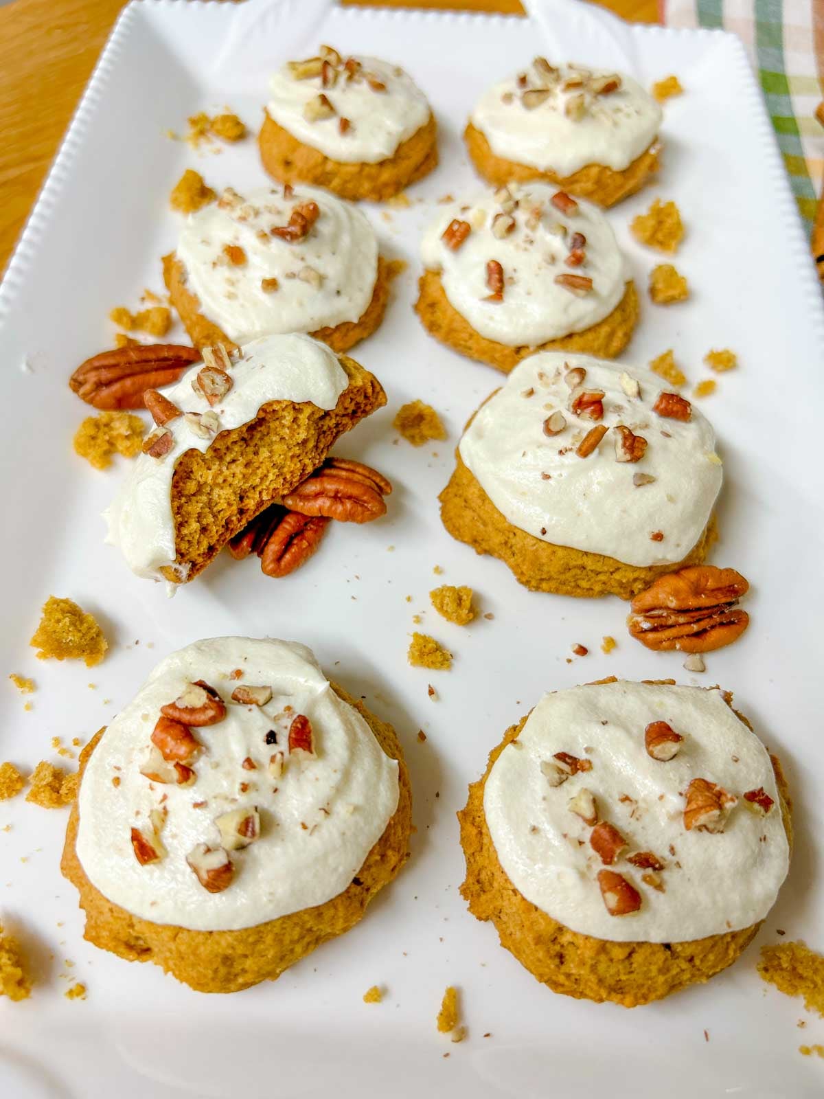 a plate of pumpkin spice cookies. there are nuts to garnish
