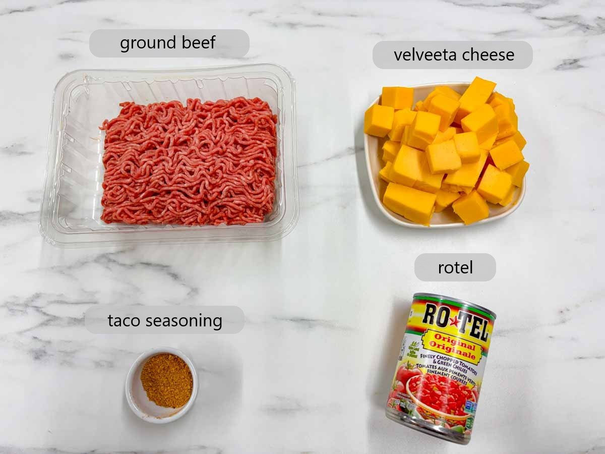 kitchen counter with ingredients and text overlays reading ground beef, velveeta cheese, taco seasoning, and rotel