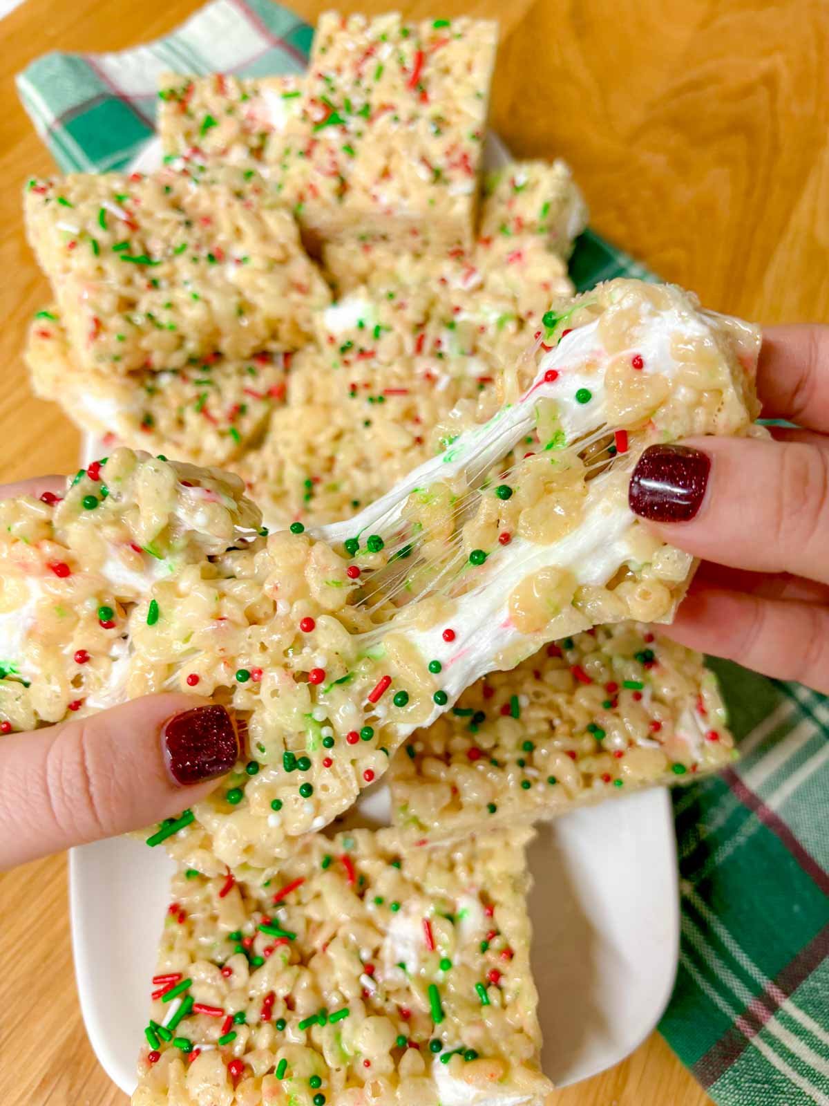 a white platter of sugar cookie rice krispie treats. one is ripped in half