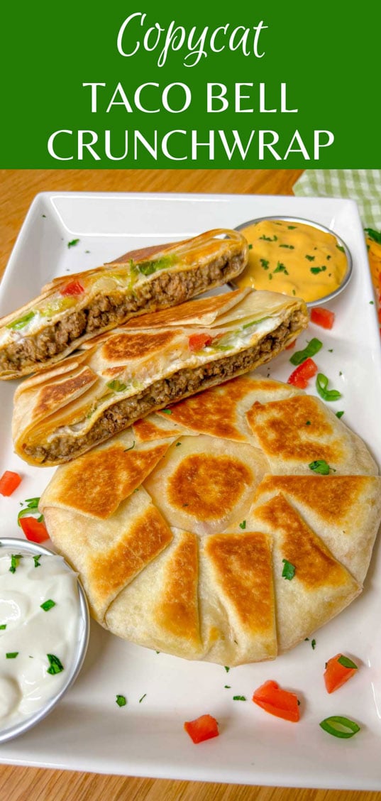 a white plate has two crunchwrap supremes on it. one is cut in half and stacked