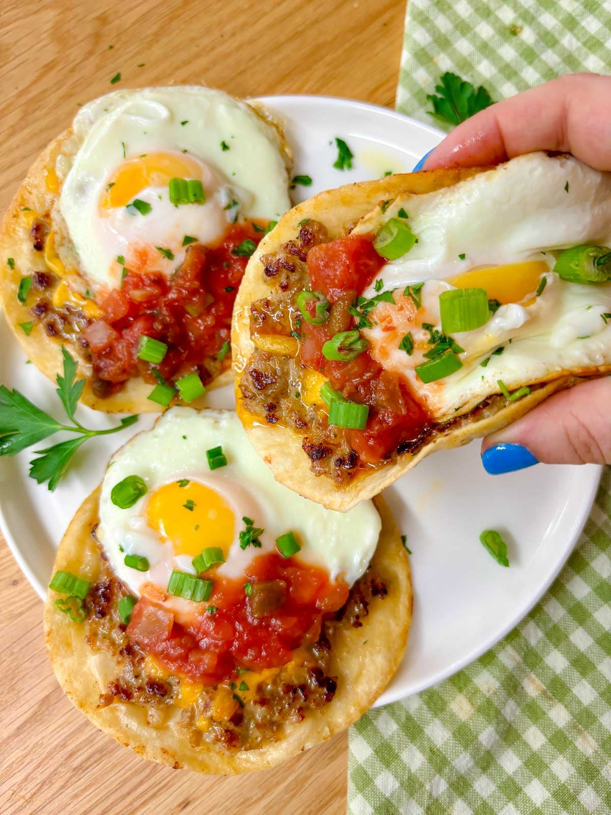 a breakfast taco is held close to the camera