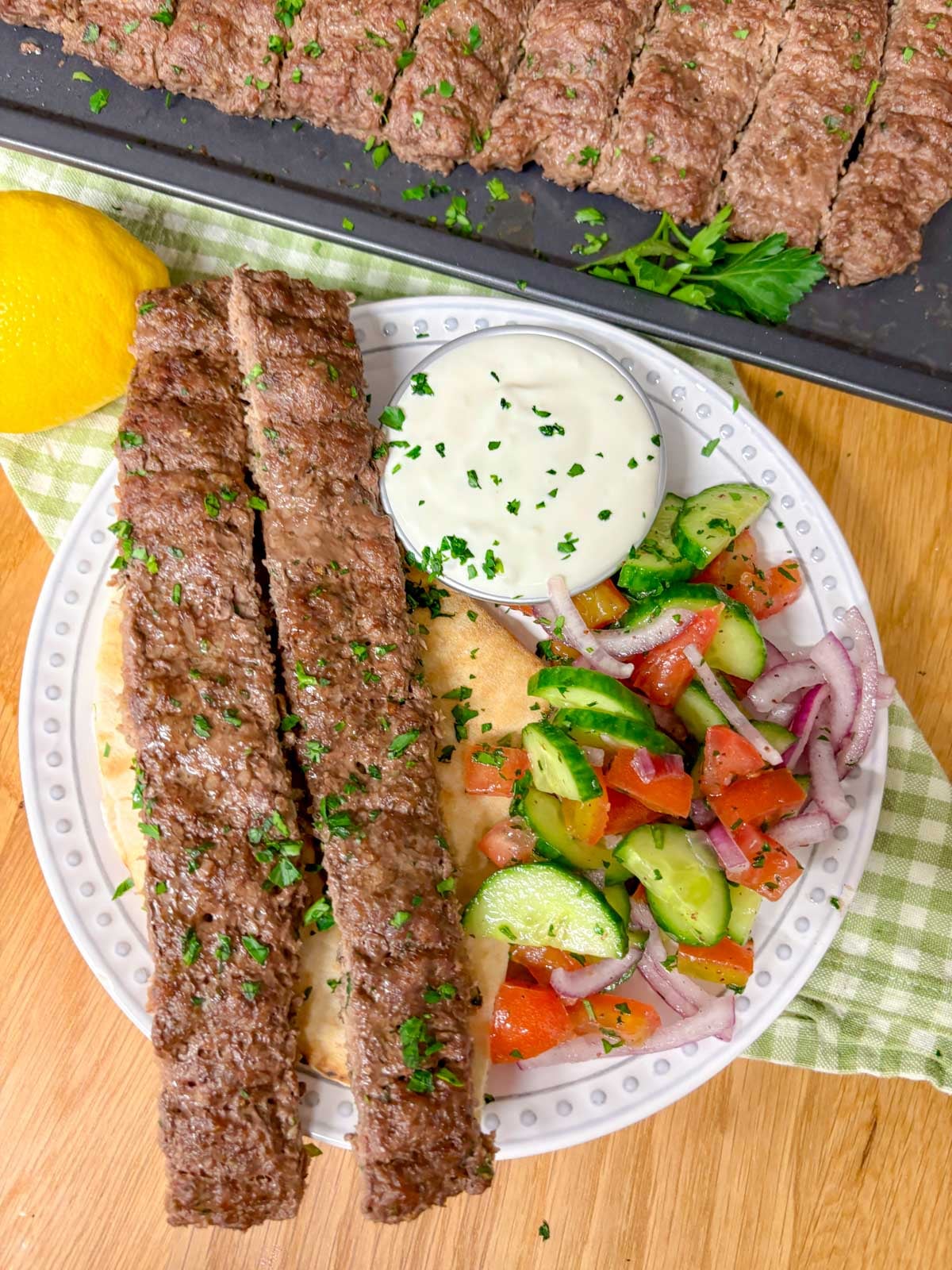 close up of the beef kebab dinner plated on a round dinner plate