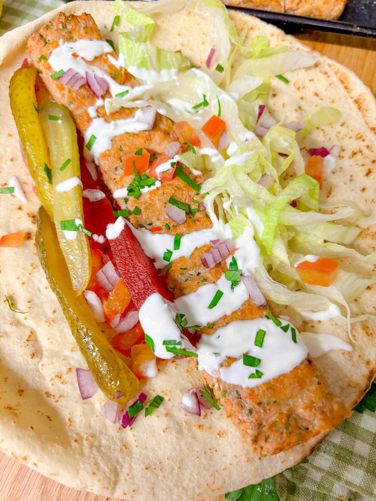 close up of an unrolled chicken kebab wrap