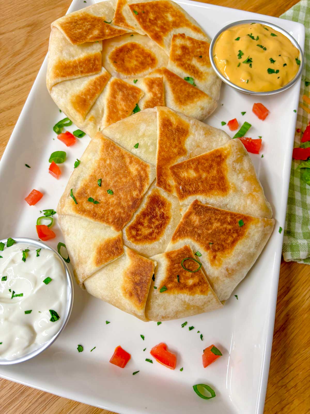 a white plate has two crunchwrap supremes on it