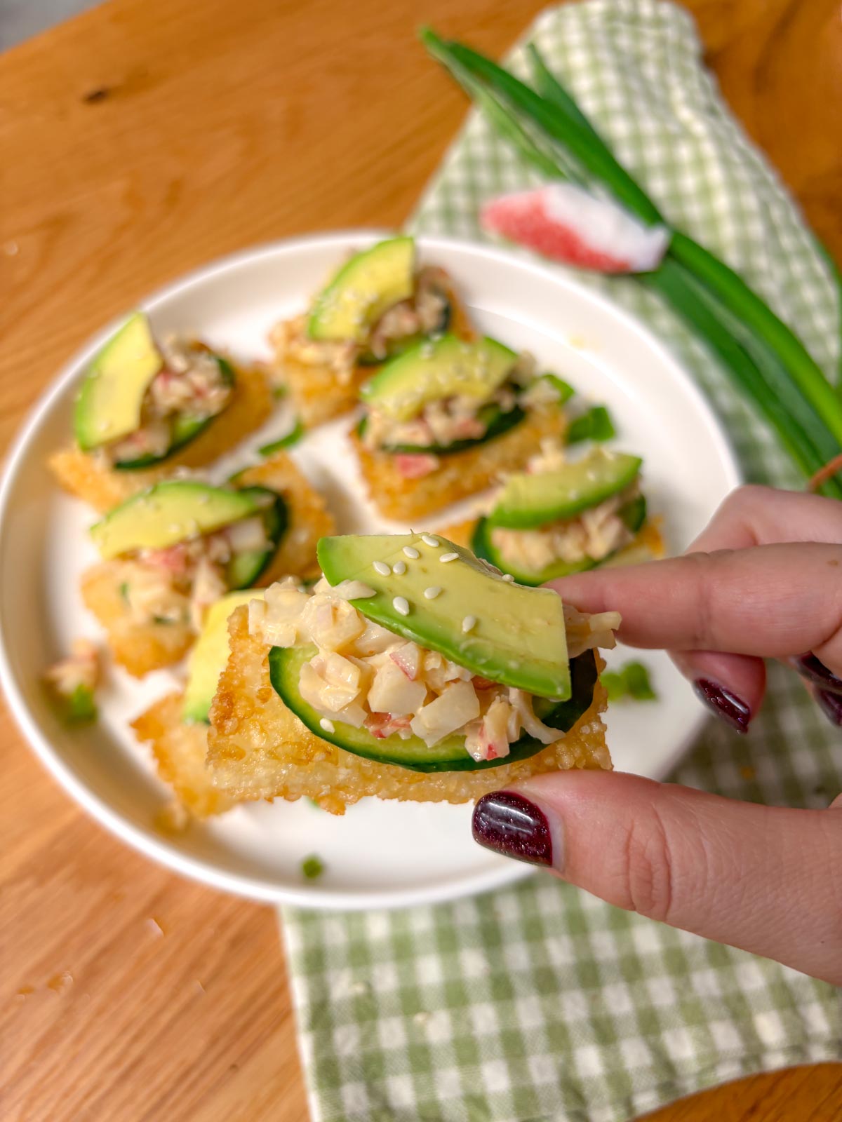 one sushi rice bite is held close to the camera