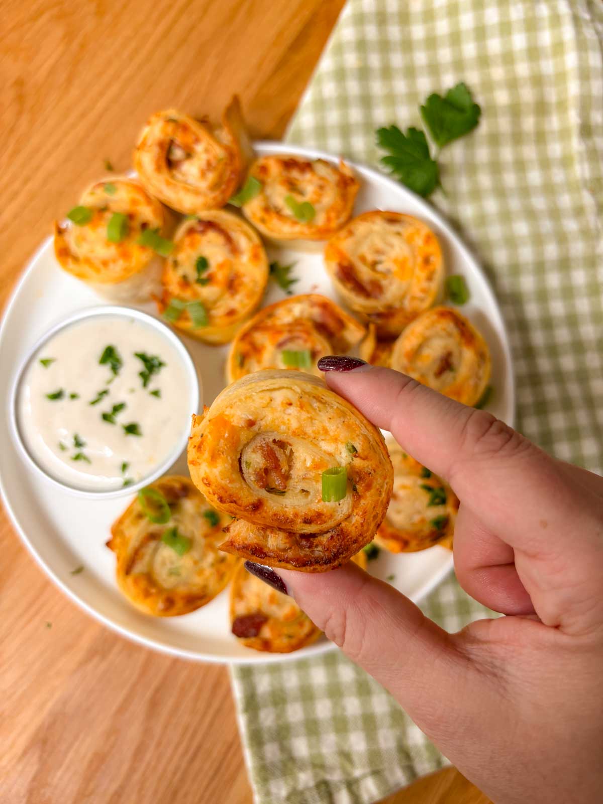 a crispy pinwheel is held close to the camera