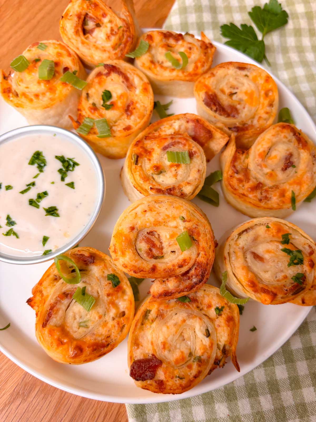 crispy air fried chicken bacon ranch pinwheels are on a platter with ranch to dip
