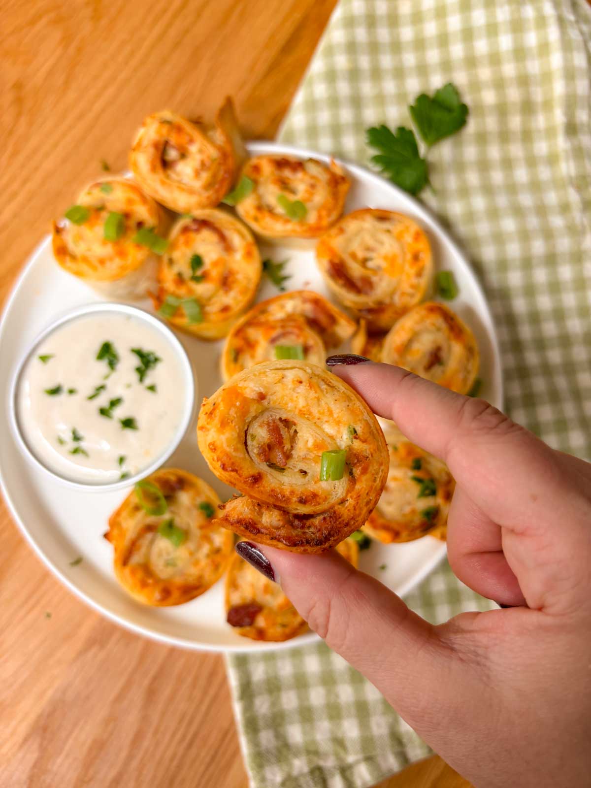 an air fried pinwheel is held close to the camera