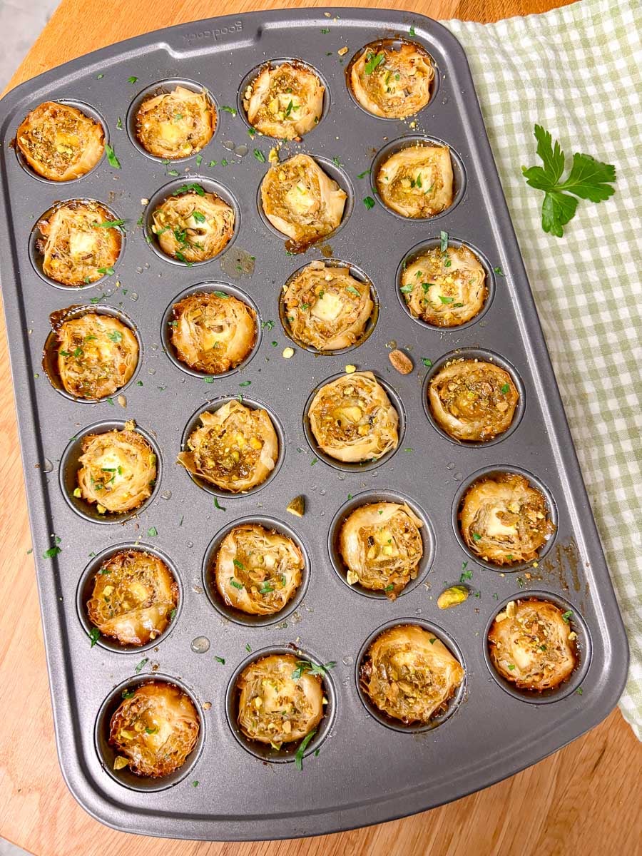 a 24 cup mini muffin tin is filled with baked feta bites