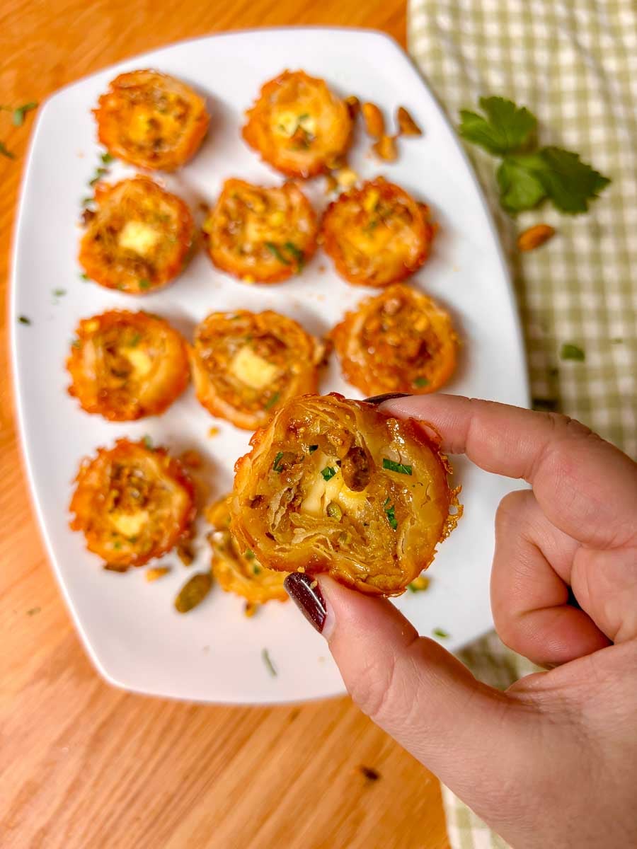 a feta bite is held close to the camera