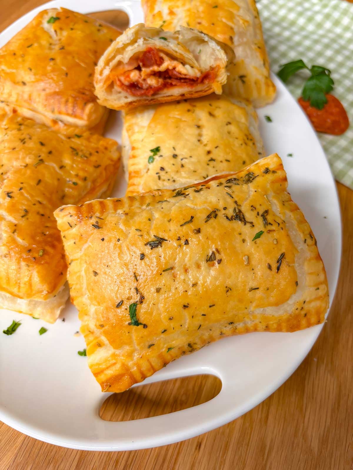 platter of hot honey pizza pockets with one cut in half to show the pizza filling