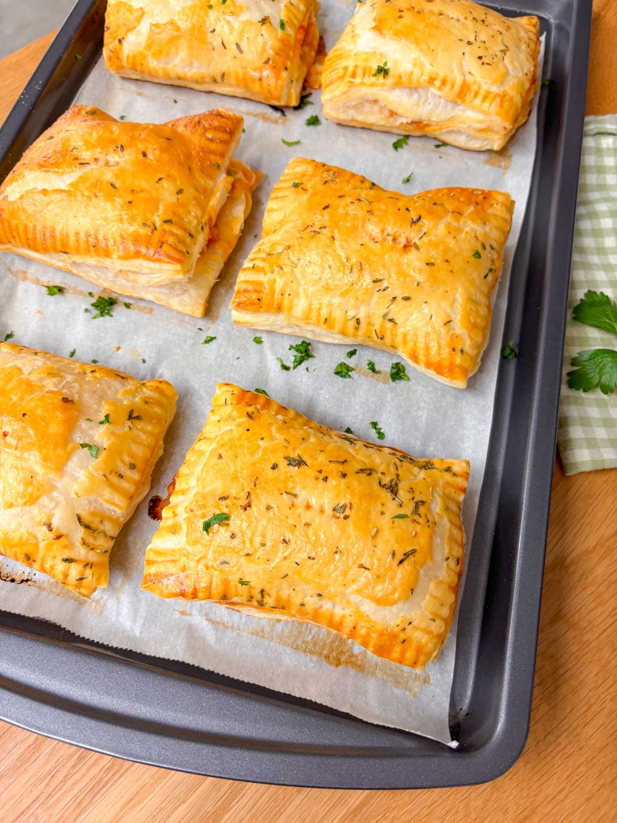 a baking tray filled with hot honey pizza pockets.